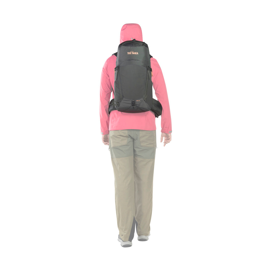 Back view of woman wearing the 24 litre Tatonka Norix women's pack with detachable padded hip belt in place