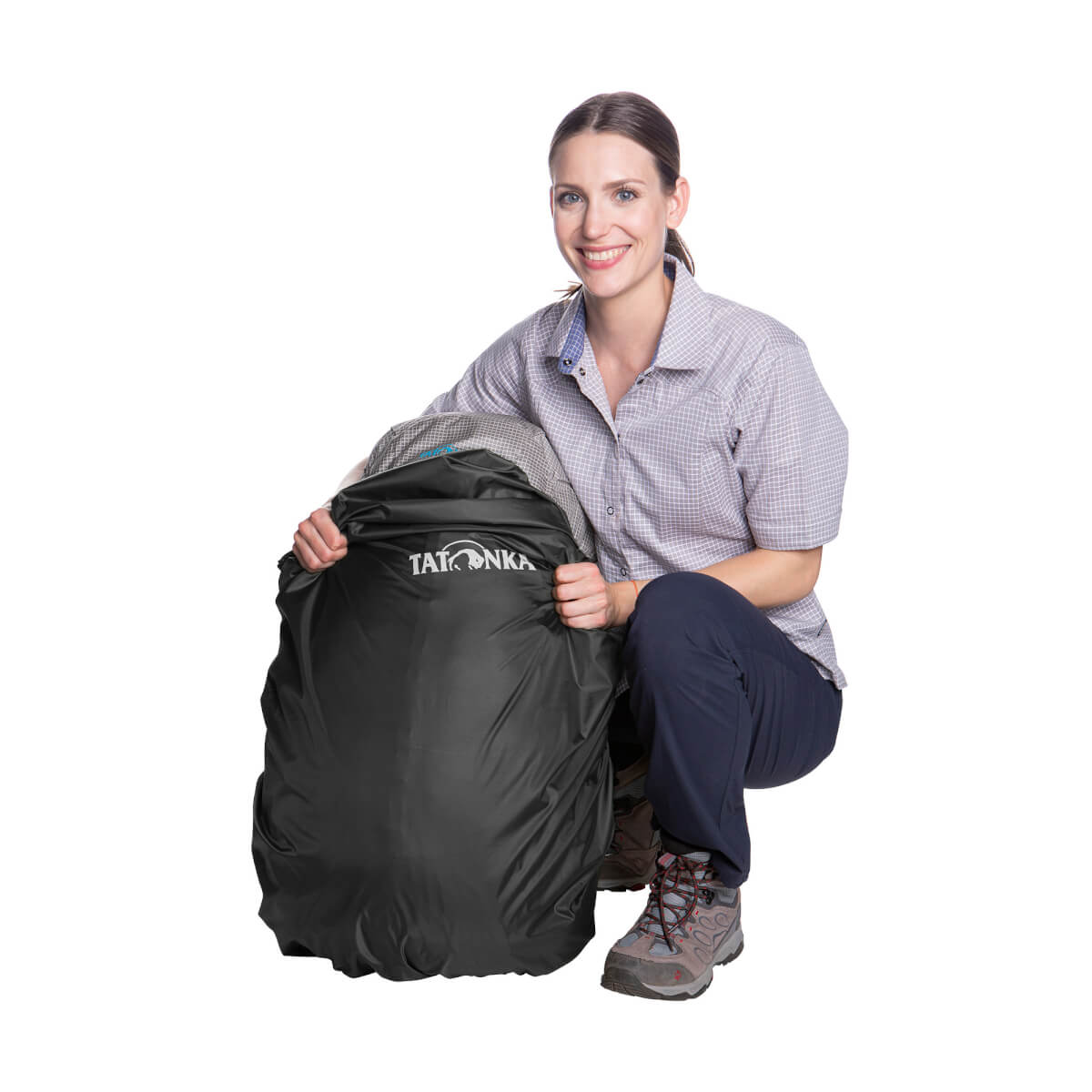 Person putting pack inside Tatonka rain cover - Black