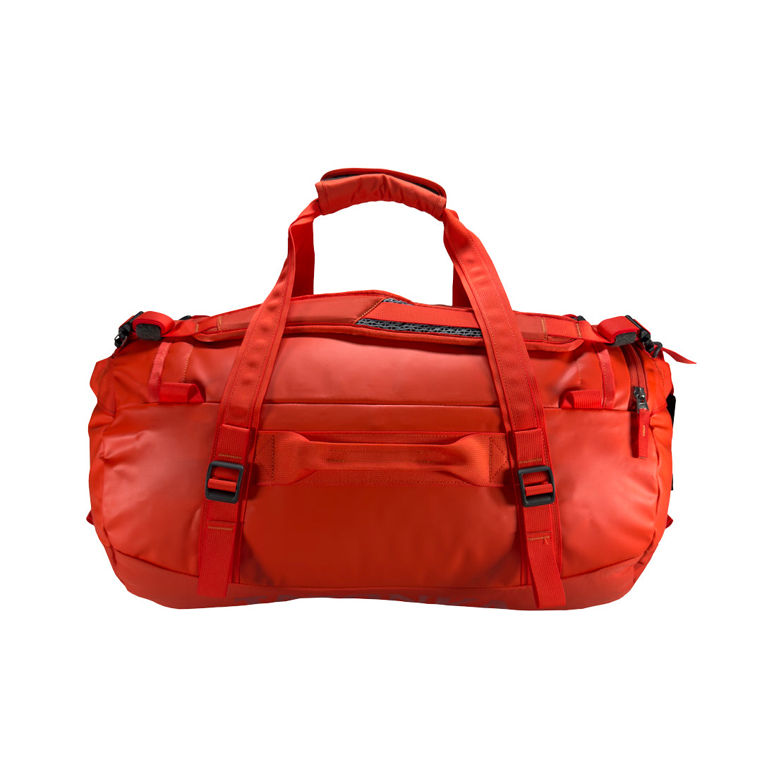 Back view of 45 litre Tatonka barrel bag with adjustable, top carry handles, grab handles on all sides, and padded, removable and adjustable backpack shoulder straps. Main body has compression straps and a padded bottom - Red