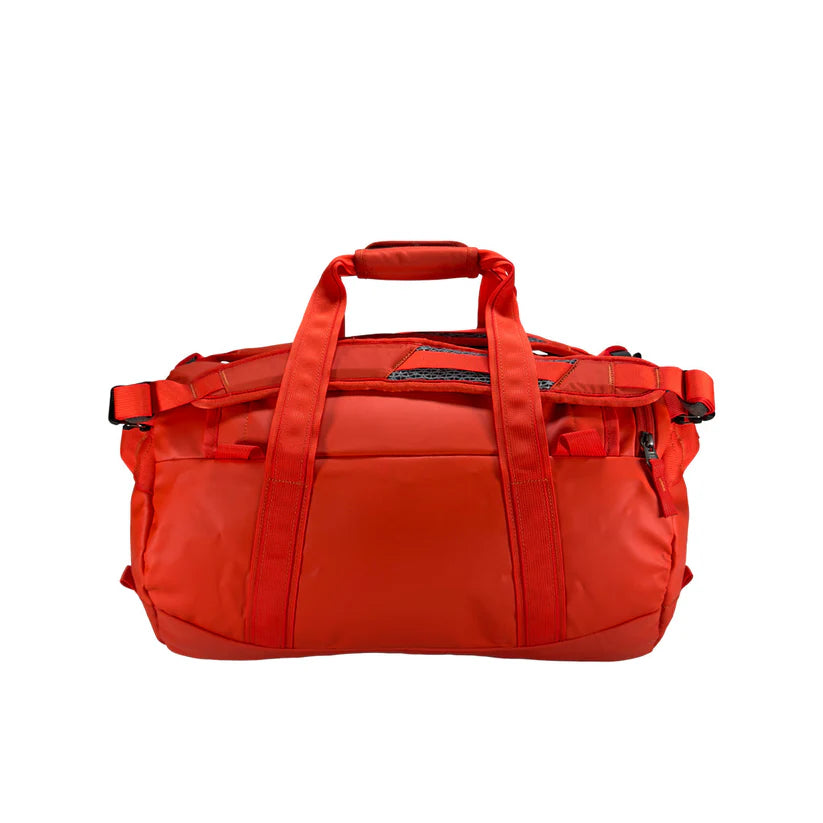 Back view of 25 litre Tatonka barrel bag with adjustable, top carry handles, grab handles on both ends, and padded, removable and adjustable backpack shoulder straps. Main body has compression straps and a padded bottom - Red