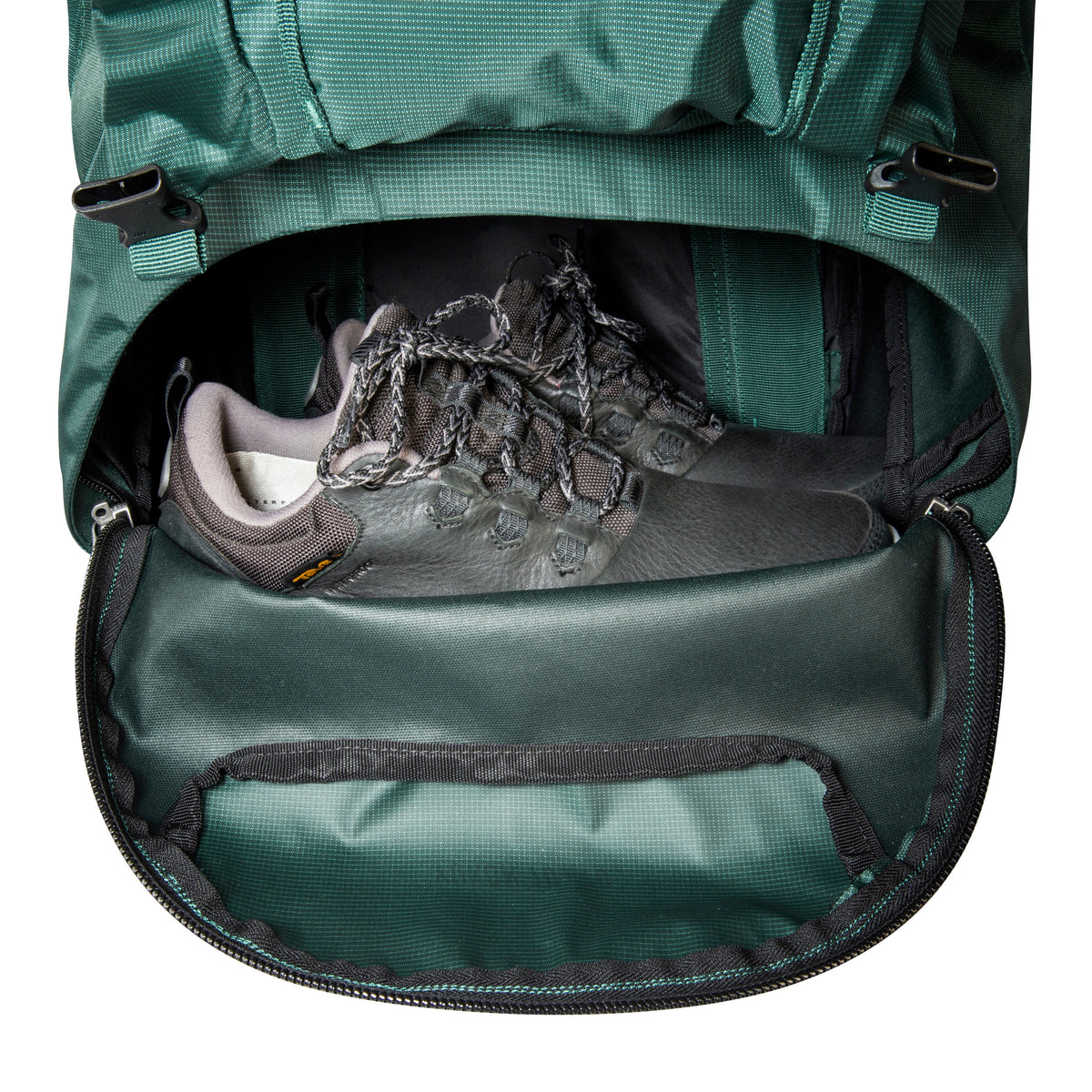 Front view of 70/10 litre Tatonka branded Yukon pack showing bottom compartment unzipped fully with shoes stored in place – Jasper