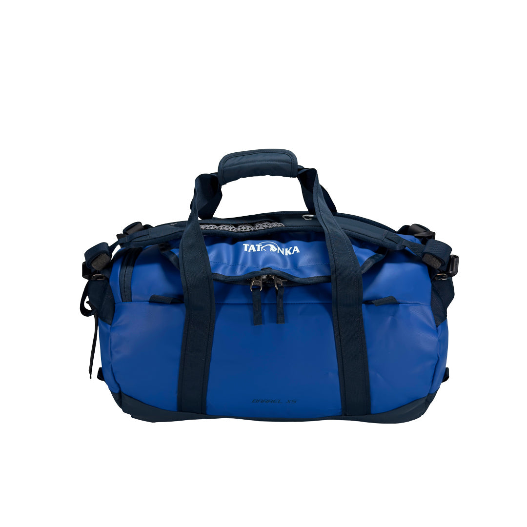 Front view of 25 litre Tatonka barrel bag with adjustable, top carry handles, grab handles on both ends, and padded, removable and adjustable backpack shoulder straps. Main compartment top opening has 2-way lockable zip sliders, while main body has compression straps and a padded bottom - Blue