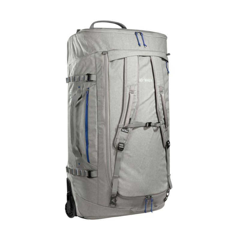 Back three-quarter view of 140 litre Tatonka Duffel Roller with side zip pocket and compression straps, stowaway shoulder straps, grab handles on top and side, large zip opening for main compartment with lockable zip slider – Grey