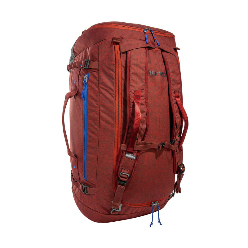 Back three-quarter view of sixty-five litre Tatonka Duffle Bag with grab handles on top and side, compression straps, stow away shoulder straps, lockable zip slider, large zip opening for main compartment and side zip pocket – Tango Red