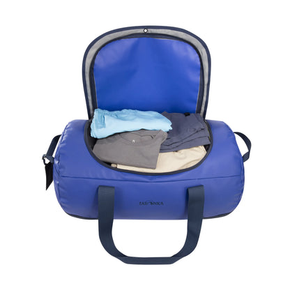 Open view packed with clothes of the Tatonka Basic Barrel 65 L in matte blue | TADI.6981.410
