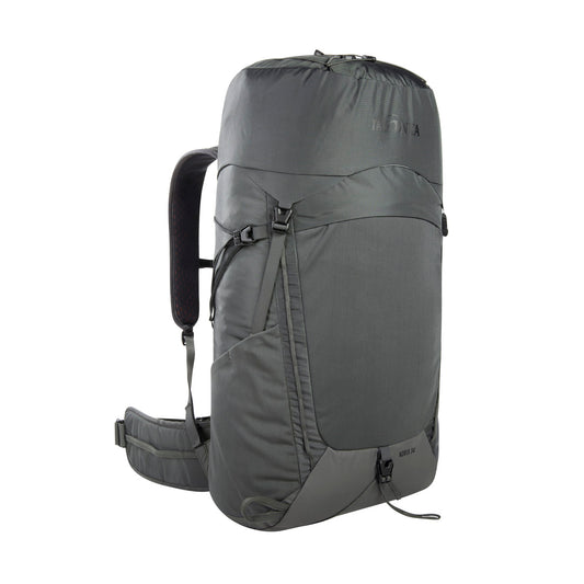 Front three quarter view of 34 litre Tatonka Norix pack with snow guard, fixation for hiking poles, load control strips and side compression straps, top handle, lid compartment with key holder and elastic zigzag lacing. Also features side elastic pockets, gear loops and elastic pocket on front, with fixation straps at the bottom – Titan Grey | Ships from Melbourne